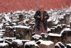 Masara Murtayeva, 80,  prays at a cemetery, a memorial to the Stalin-era deportation's victims, in Grozny, the capital of the Russian breakaway region of Chechnya, Sunday, Feb. 22, 2009. Chechens and Ingush, who were also victims of the 1944 deportations, which started on Feb. 23,  to the barren steppes of then-Soviet Central Asia, marked its 65th anniversary on Sunday with visits to mosques and cemeteries. (AP Photo/Musa Sadulayev)